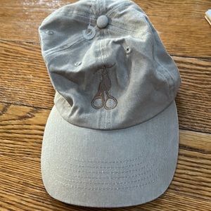 Tan cap, stork scissor emblem embroidered on front.  Adjustable w/Velcro